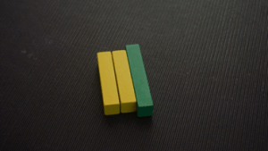 There are two yellow rods next to the dark green one